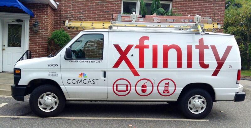 A Comcast service van parked in front of a residence.