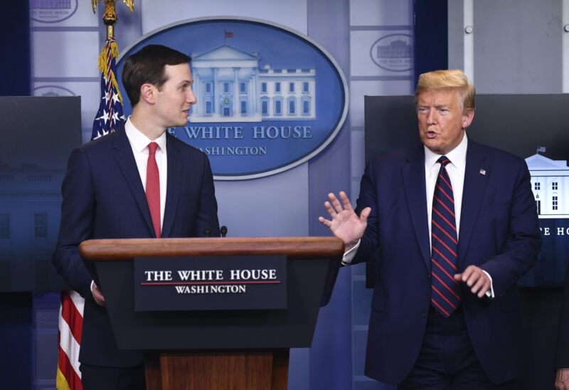 President Trump speaking while Jared Kushner looks on at a White House press conference.