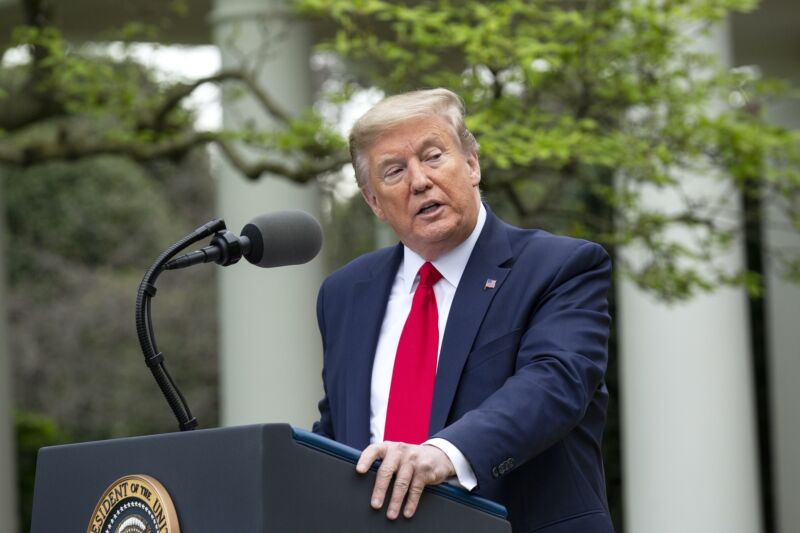 President Trump speaks in front of a podium at the White House's Rose Garden.