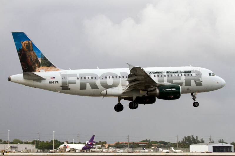 A passenger jet with the word Frontier emblazoned on it lifts off.