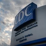 Huge facade for CDC headquarters against a beautiful sky.