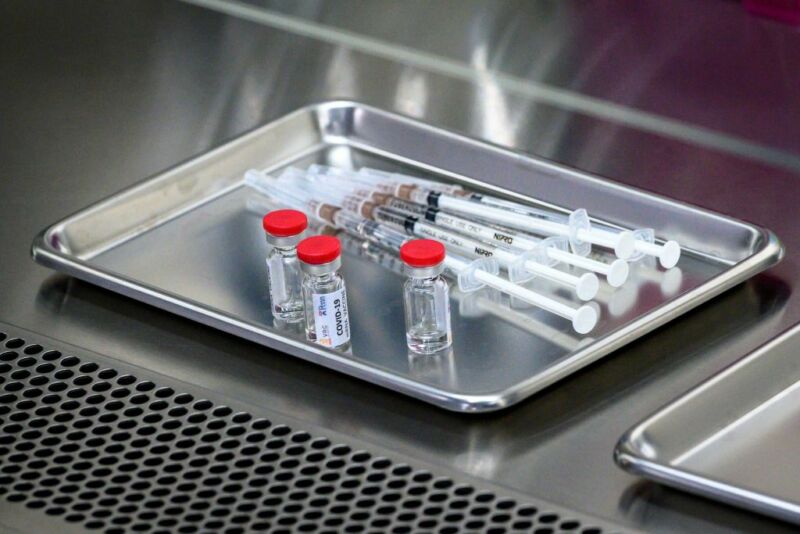 Image of vials and syringes on a tray.