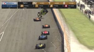 A screenshot of an IndyCar iRacing event with a car vaulting into the air after being hit.