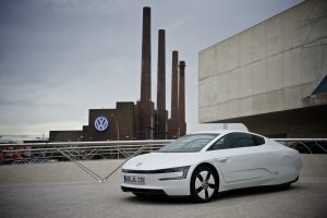 A VW XL1 with VW's factory in the background