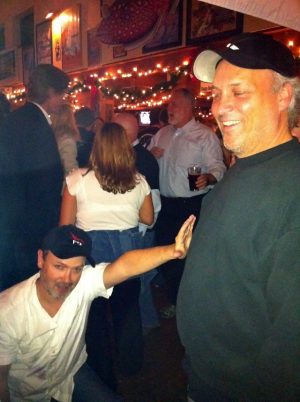 Launch Director Tim Buzza salutes technician Marty Anderson at the post-launch party.