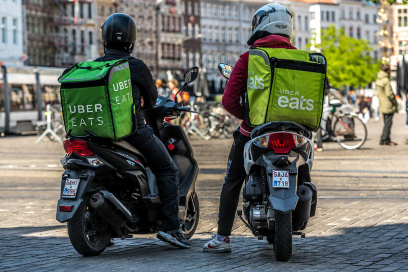 Two Uber Eats delivery courier wait outside Mc Donalds fast food in Ghent, Belgium on May 14, 2020. As Belgium takes steps in easing Restrictions, Restaurant and cafe are not allowed to open to customers only fast food and take away is allowed. restaurants and restaurants may not reopen before June 8. (Photo by Jonathan Raa/NurPhoto via Getty Images)