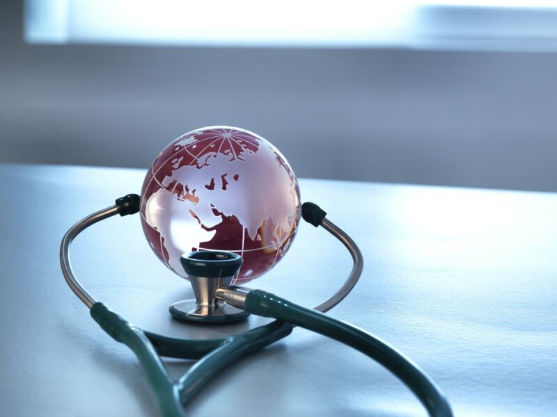 A stethoscope being used on a small globe.