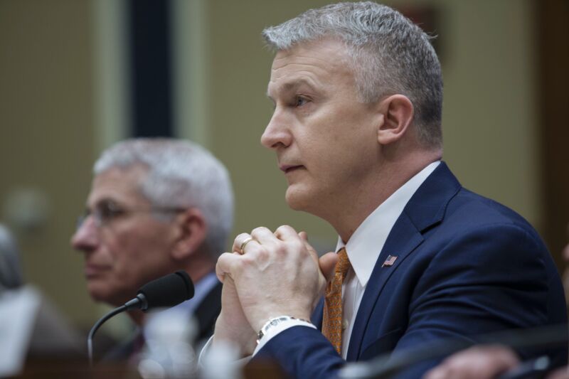 US health officials Rick Bright and Anthony Fauci sit at a table during a congressional hearing.