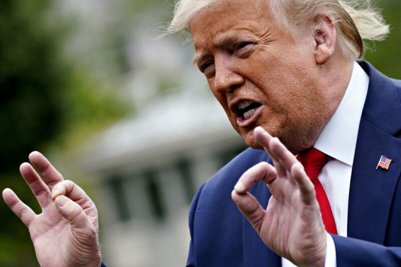 President Donald Trump speaking and gesturing with his hands.