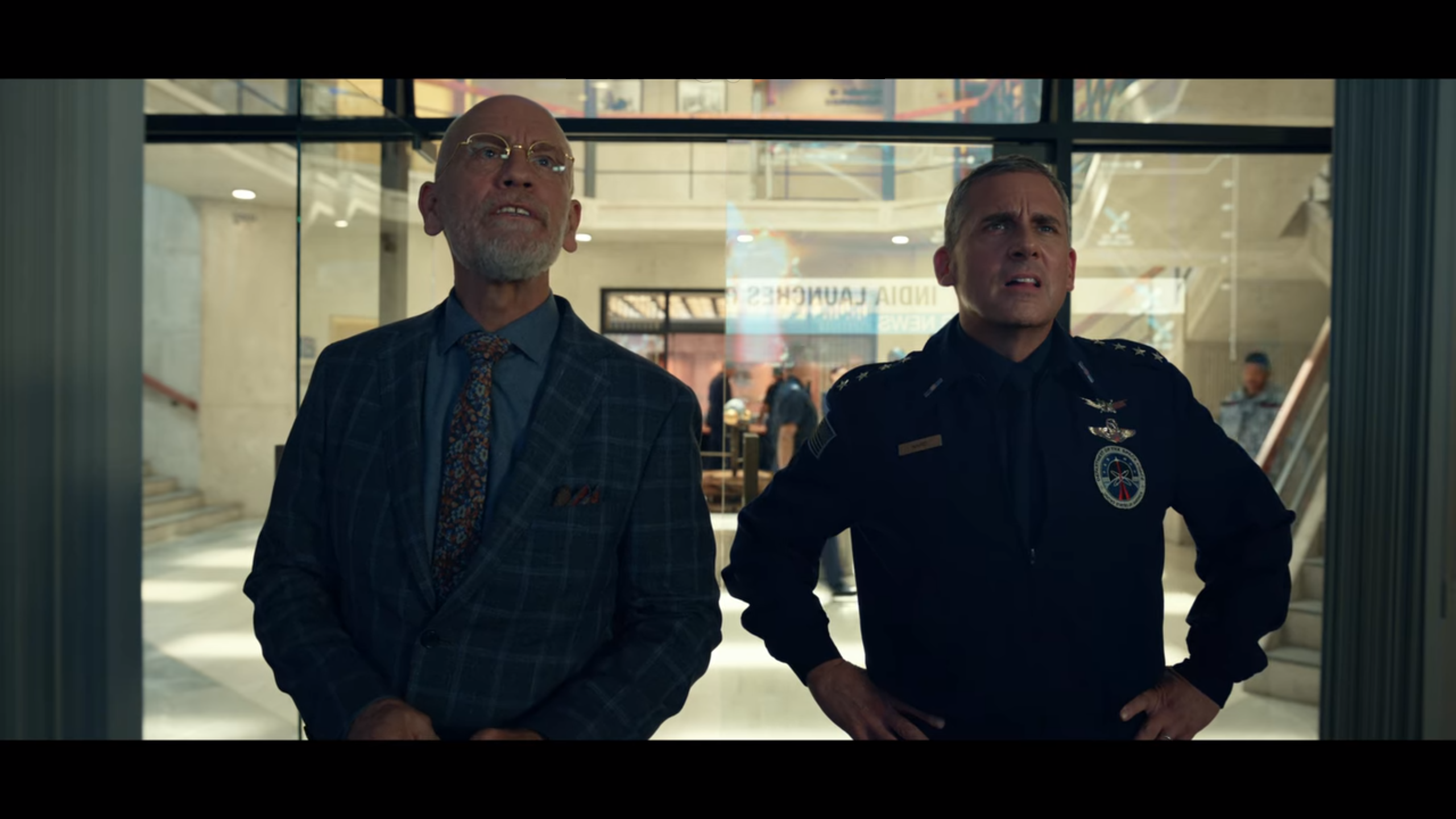 (image) John Malkovich, left, and Steve Carell, right, have a lot of bad news to endure during <em>Space Force</em>'s first ten-episode season, now live on Netflix.