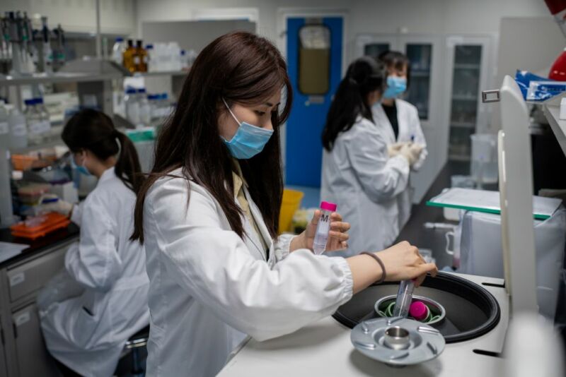In this picture taken on April 29, 2020, engineers work on an experimental vaccine for the COVID-19 coronavirus at the Quality Control Laboratory at the Sinovac Biotech facilities in Beijing