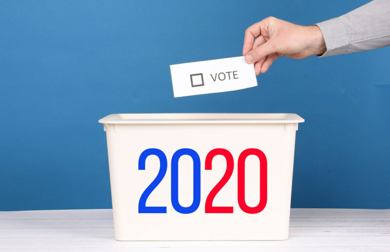 Stock photo of a slip of paper being dropped into a bin marked 2020.