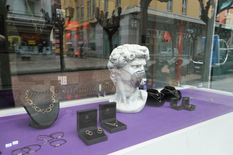 A store window includes a bust of Michelangelo's David.
