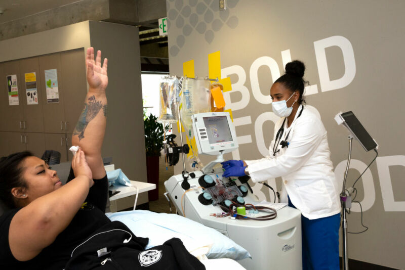 Image of a woman finishing a blood donation.