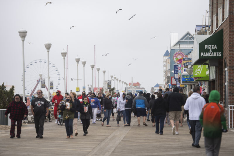 Crowds of people walk along the Ocean City Boardwalk during Memorial Day weekend on Sunday, May 24, 2020.