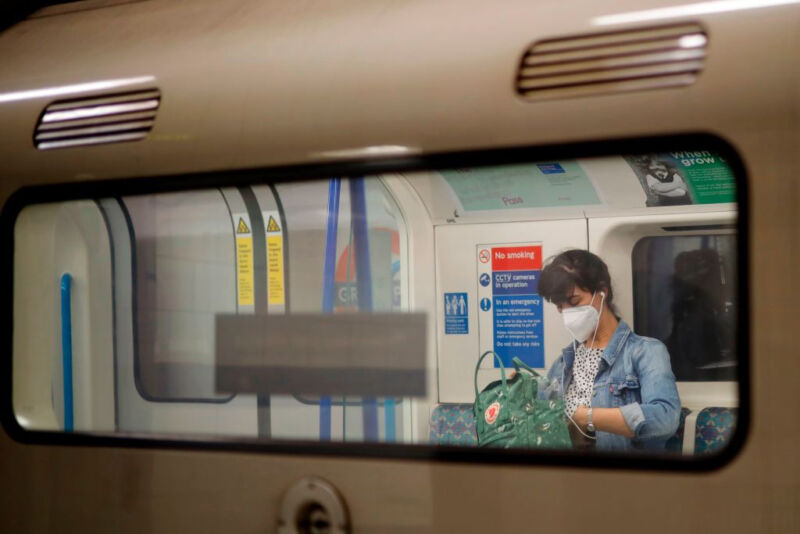 Image of a masked person on a commuter train.