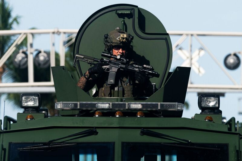 A Miami Police officer watches protesters from an armored vehicle on May 31, 2020. 