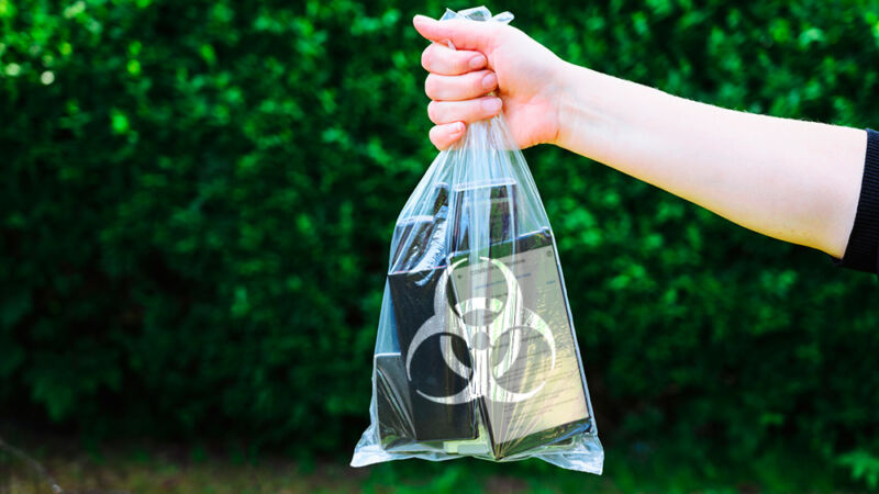 Phones and tablets in a plastic bag with a biohazard label.