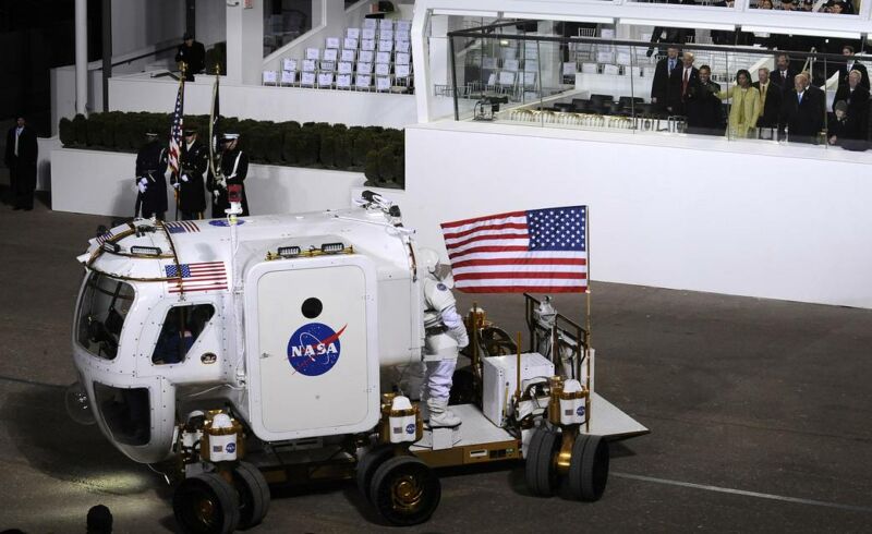 President Barack Obama, Michelle Obama and Vice President Joe Biden watch as the NASA Lunar Electric Rover stops in front of the presidential reviewing stand on Pennsylvania Avenue on Tuesday, Jan. 20, 2009.