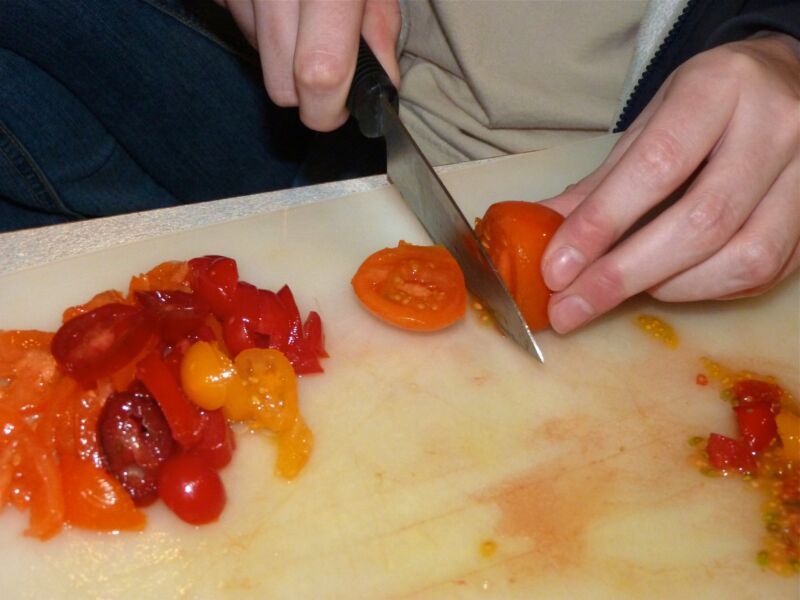 Image of someone slicing tomatoes.