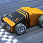A cartoon race car appears to be made out of a comically shaped 9-volt alkaline battery.