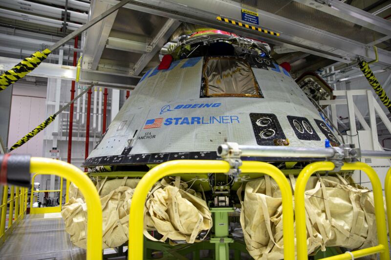 A space capsule sits in a clean room.