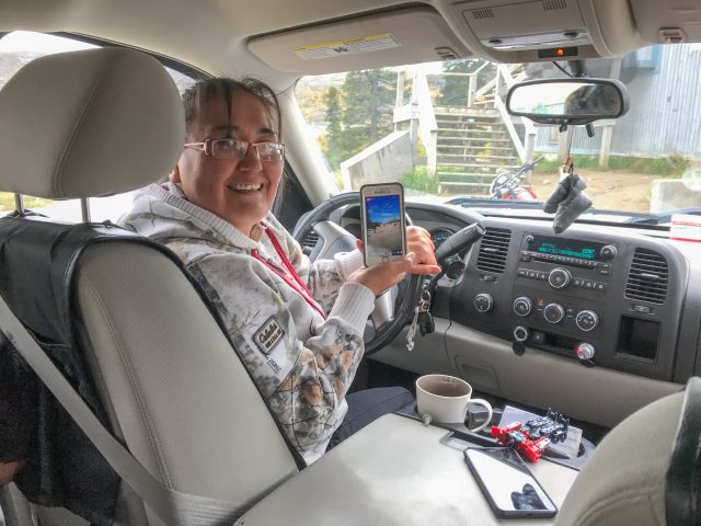 A mother uses cell service to watch her child's cross-country race.