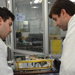 Engineers inspect one of the two MarCO CubeSats in 2016 at JPL.