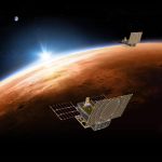 An artist's rendering of the twin MarCO spacecraft flying over Mars with Earth in the distance.