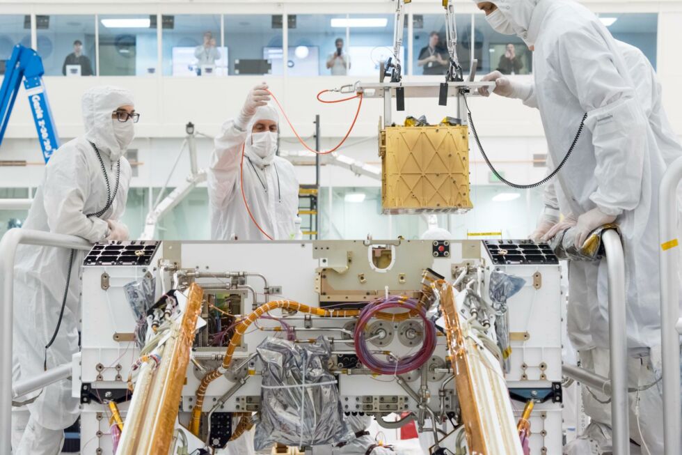 Members of NASA's Mars 2020 project install the Mars Oxygen In-Situ Resource Utilization Experiment (MOXIE) into the chassis of NASA's next Mars rover.