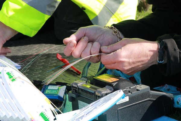 Preparing fiber-optic cable for fusing. 