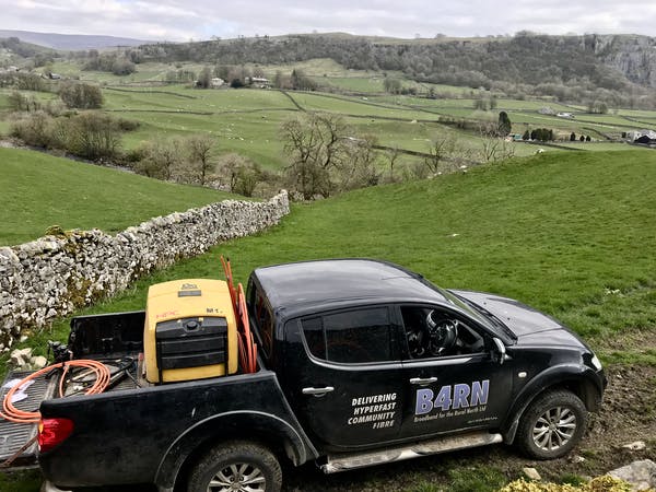 B4RN vehicle parked in a field in rural northwest England during a fiber installation. 