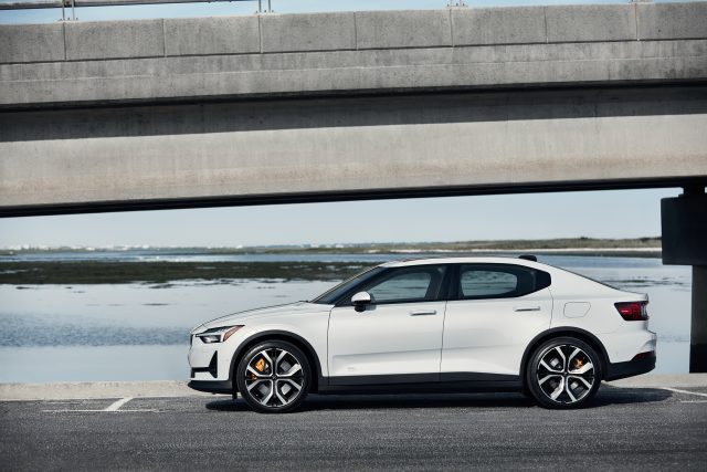 A white polestar 2 parked by a bridge