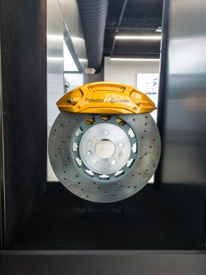 A brake disk and gold-painted caliper.