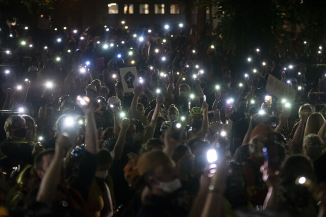 Phones have become an essential tool for modern protest organizing. Here, protesters hold their cellphones in the air during a Black Lives Matter event in front of the Multnomah County Justice Center on July 20, 2020 in Portland, Oregon. 