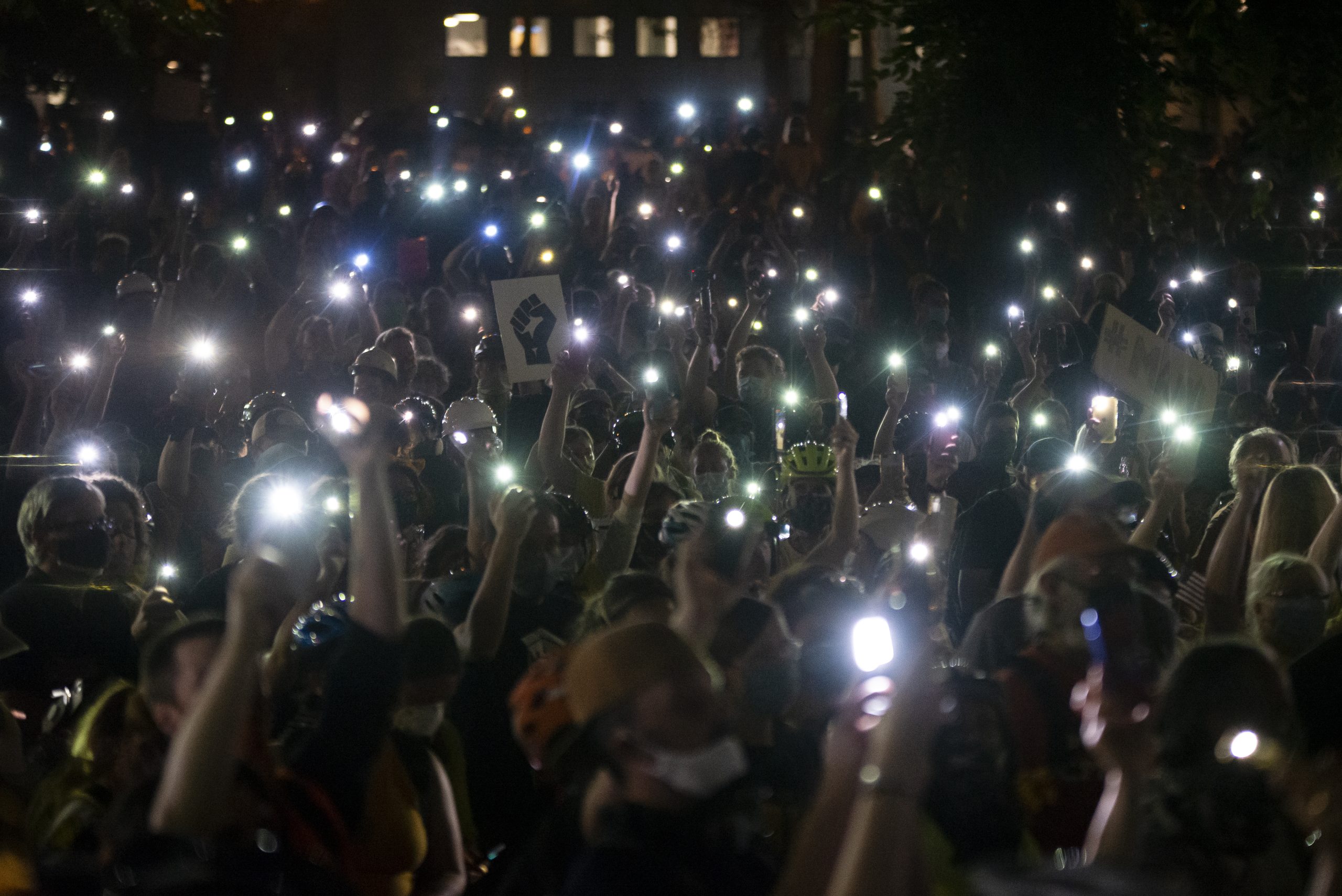Phones have become an essential tool for modern protest organizing. Here, protesters hold their cellphones in the air during a Black Lives Matter event in front of the Multnomah County Justice Center on July 20, 2020 in Portland, Oregon.