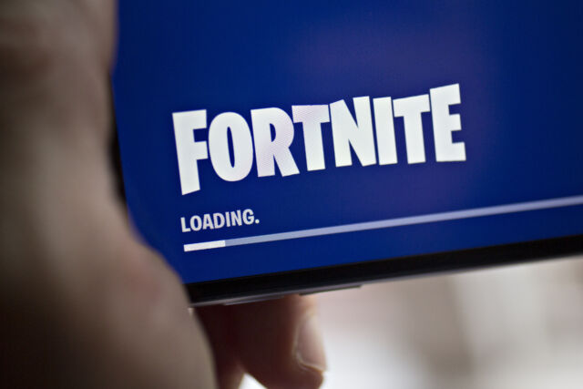 A <em>Fortnite</em> loading screen displayed on an iPhone in 2018, when Apple and Epic <em>weren't</em> at each other's throats.