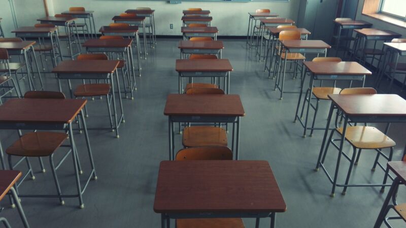 A school classroom filled with empty desks.