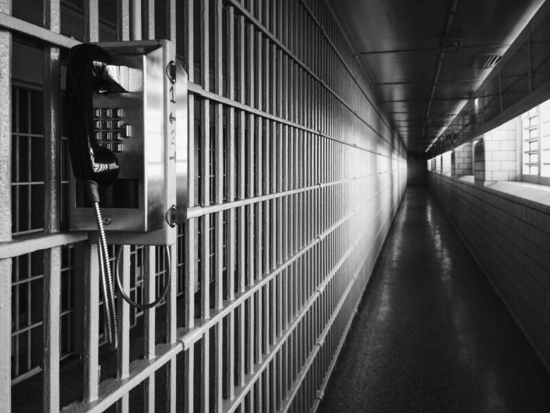 A telephone inside a prison hallway.