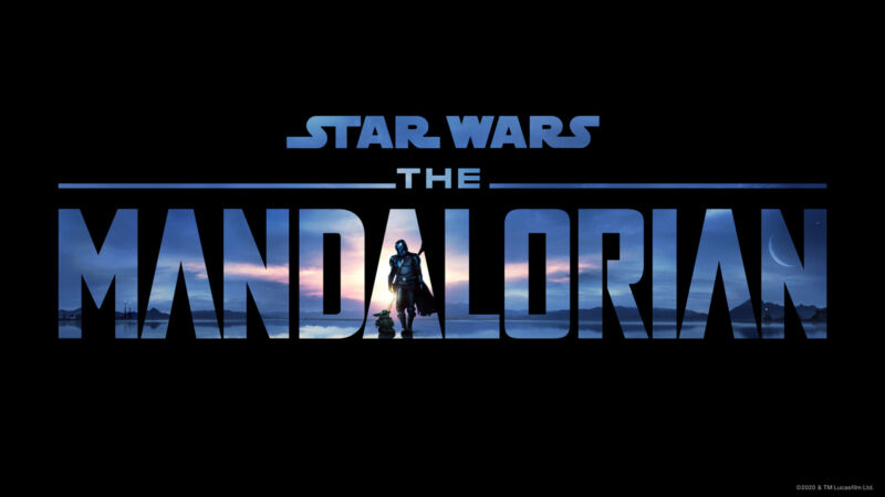 Characters walk in an extraterrestrial sunset outlined by the word Mandalorian.