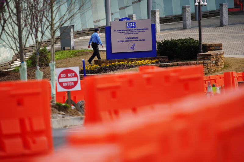 A security guard walks on the grounds of the Centers for Disease Control and Prevention (CDC) headquarters in Atlanta, Georgia, US, on Saturday, March 14, 2020. 