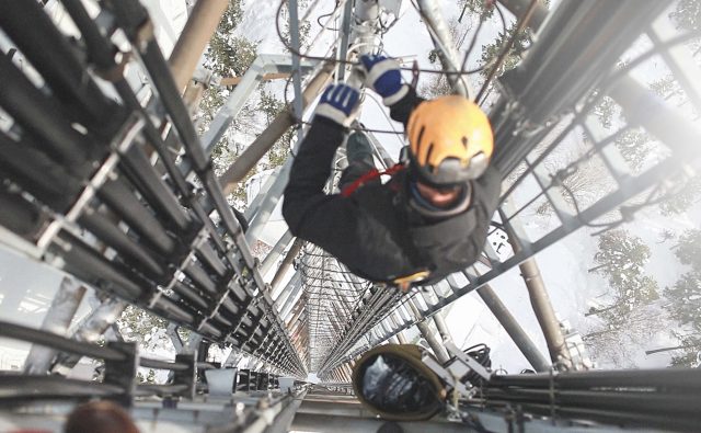 This person is adding additional Gs to a transmission tower.