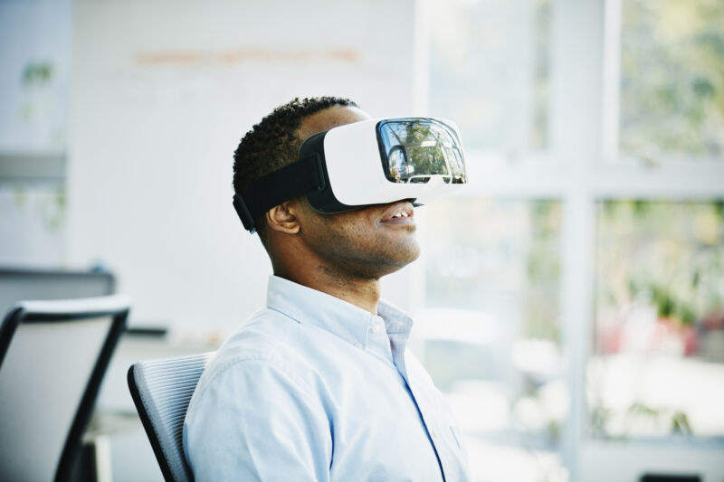 Businessman using virtual reality headset