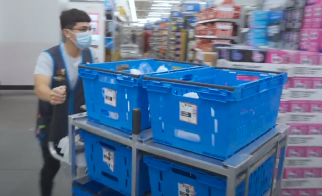 Most Walmart+ orders will be fulfilled directly from a local store—in this scene from a promotional video, a staffer picks products directly from shelves for delivery.