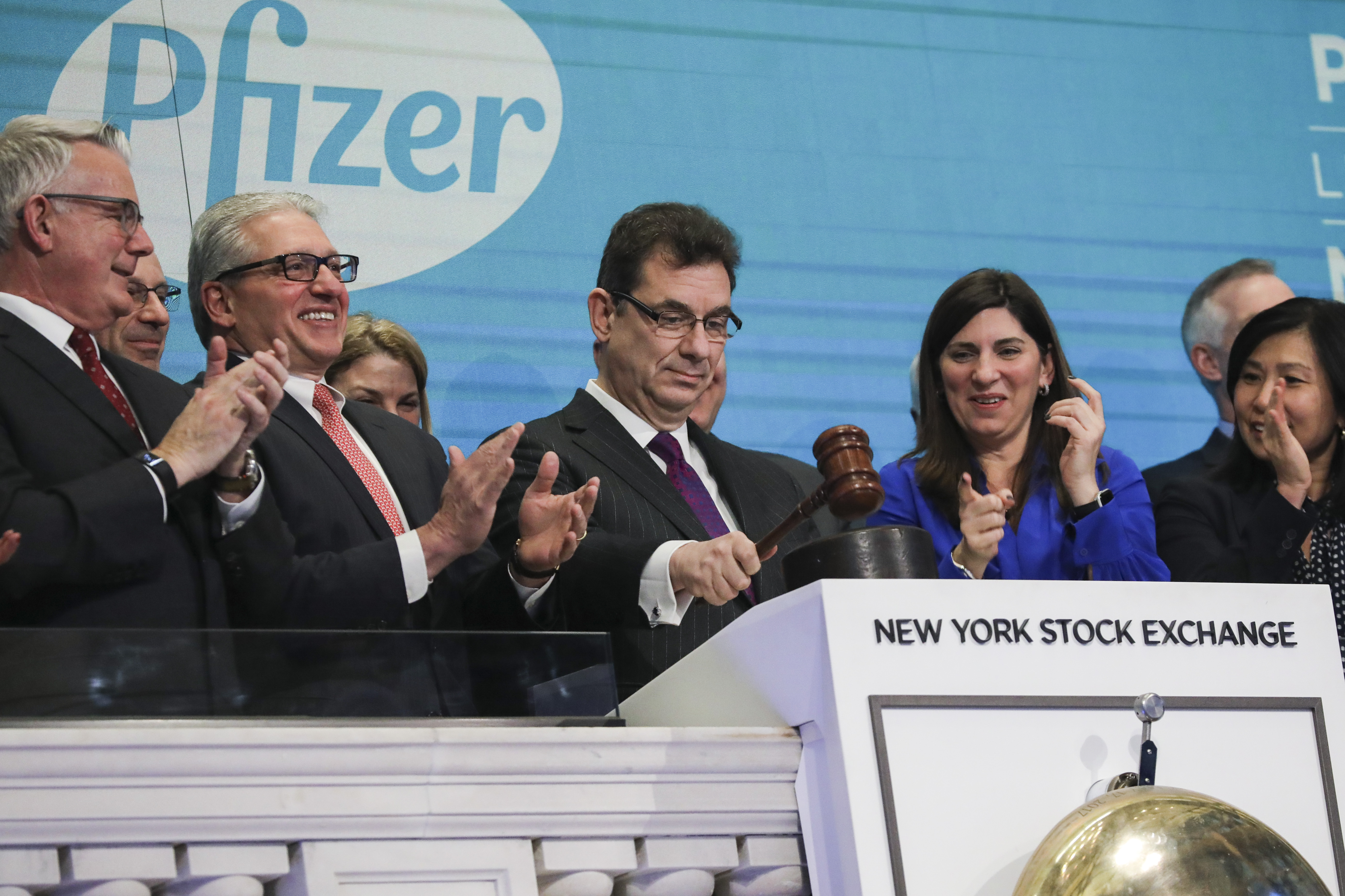 Albert Bourla, chief executive officer of Pfizer pharmaceutical company, bangs a gavel after ringing the closing bell at the New York Stock Exchange (NYSE) on Thursday afternoon, January 17, 2019 in New York City.