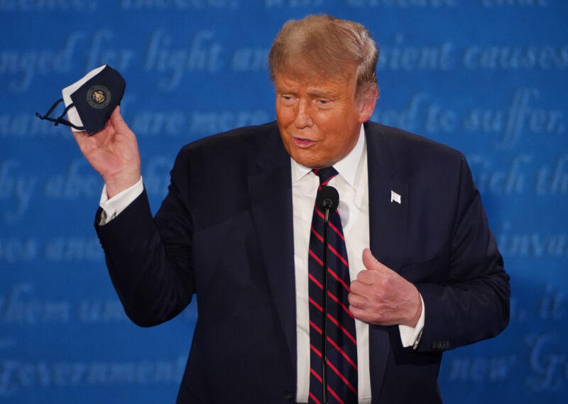 U.S. President Donald Trump holds a protective mask during the first U.S. presidential debate hosted by Case Western Reserve University and the Cleveland Clinic in Cleveland, Ohio, U.S., on Tuesday, Sept. 29, 2020.