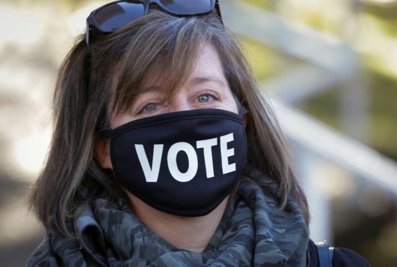 VANCOUVER, Oct. 24, 2020 - A voter wearing a face mask is seen outside a polling station during the provincial election day in Vancouver, British Columbia, Canada, Oct. 24, 2020. 