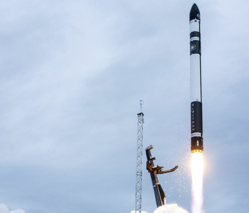 Photograph of a rocket just after liftoff on a cloudy day.