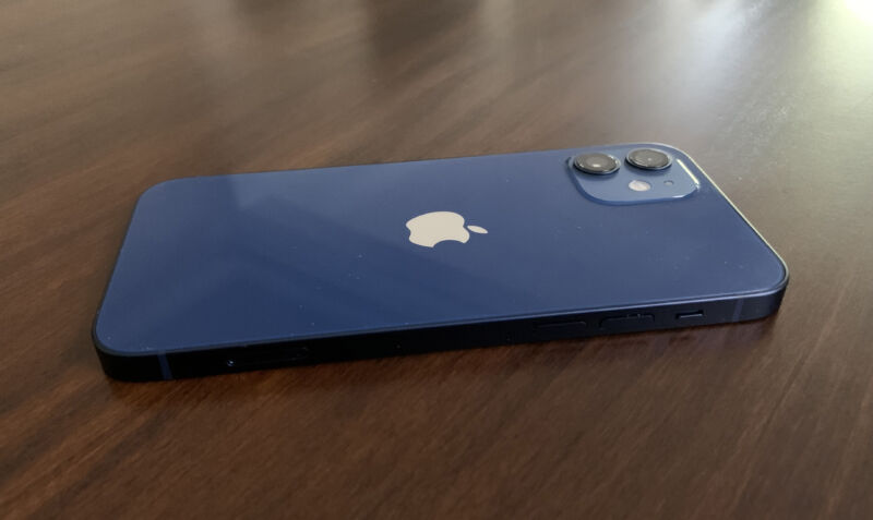 A blue iPhone 12 lying flat on a table
