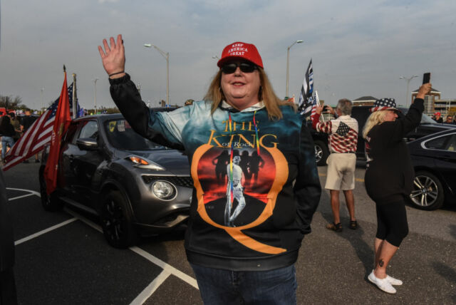 A woman wearing a sweatshirt for the QAnon conspiracy theory gestures during a pro-Trump rally on October 11, 2020 in Ronkonkoma, New York. 